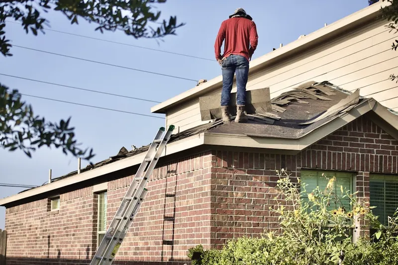 Professional roofer working on a residential roof in Hardyston